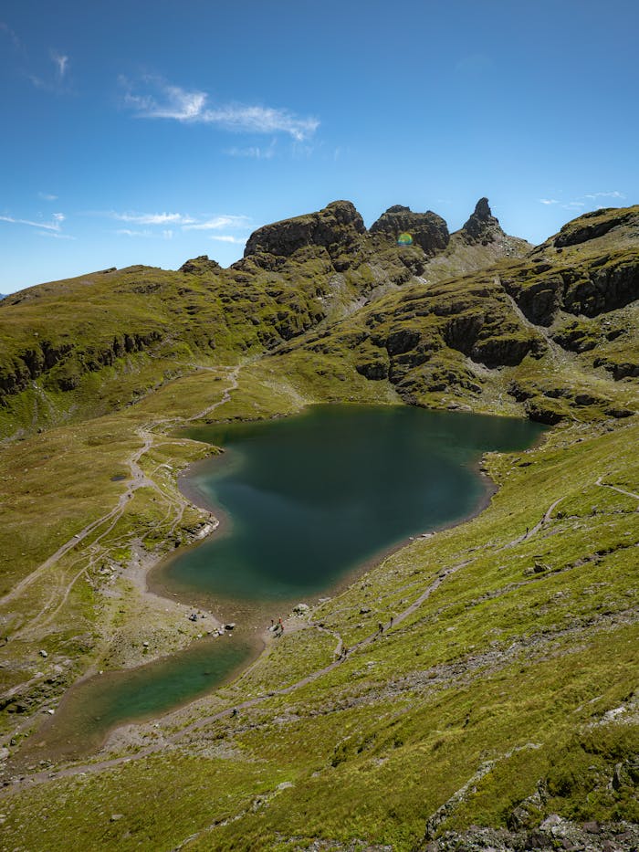Home A breathtaking view of an alpine lake surrounded by rugged mountains in Mels, Sankt Gallen, Switzerland.